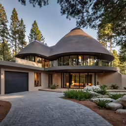 this contemporary house has two story walls and a round roof