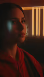 a close up of a person wearing a red sweatshirt