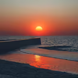 a boat sitting in the middle of the ocean