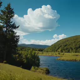 a wide river is in front of a wooded landscape