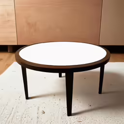 a table with white top next to brown cabinet