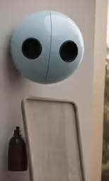 blue and grey wall mounted air freshener system near a white chair