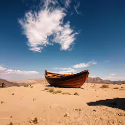 a large boat sits in the sand in the desert