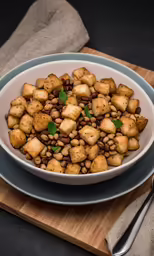a bowl of food sitting on top of a wooden cutting board