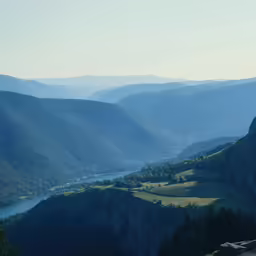 a scenic view of the mountain range with a lake below it