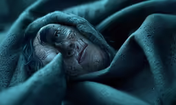 an adult woman wrapped in a blanket