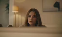 a woman in a room looking at her own self