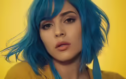a close up of a person with blue hair