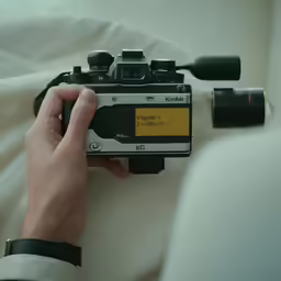 a hand that is holding a camera to record something