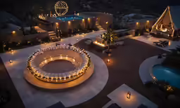 a circular fire pit lit up with candles at night