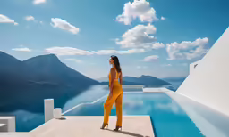 woman in yellow jumps stands near an outdoor pool