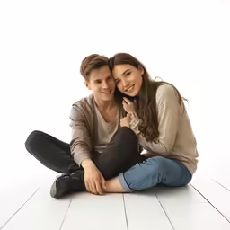 a smiling couple sitting on the floor together