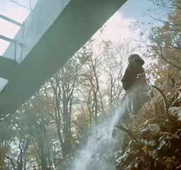 a man standing in the rain with a fire hose