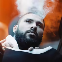 a man holding his jacket open and smoking a cigarette
