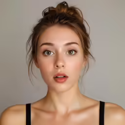a woman making a weird face while wearing a bra top