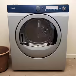 there is an automatic washing machine next to a small basket