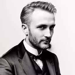a man in a suit posing for a photo