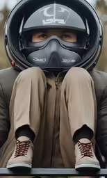 a man wearing goggles and protective gear is posing in his motorbike