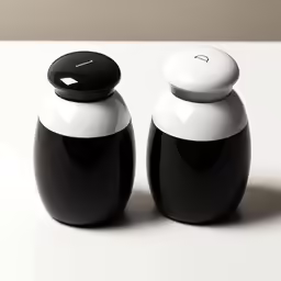 black and white vases sitting on top of a table