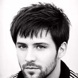 a man with a long black hair and short black beard