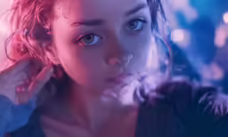 a young woman is standing behind a glass wall