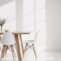 a very white chair with a wooden table