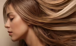 a woman with blond hair with long, curled locks