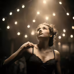 woman standing in front of a crowd of bright lights