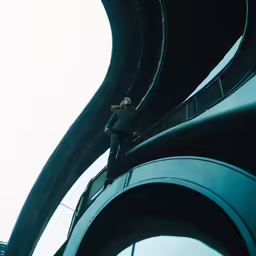the person is walking on the walkway that is above the ground