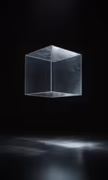 a clear box is suspended above a dark room