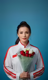 a young girl holding a bouquet of roses