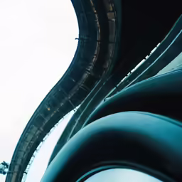 a stop light on a highway with a large tunnel in the back ground