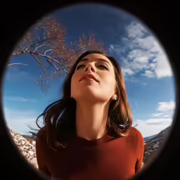 a person looking upward from behind a circular object
