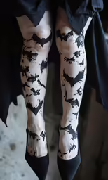 a woman with stockings on has black bats on them