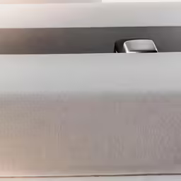 there is a gray phone in the front of this table