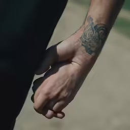 a close up shot of a man holding his hands