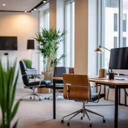 chairs and desks in an office space with large windows