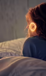 a woman lies in bed wearing glowing ear pins