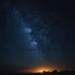 a view of the sky at night from a distant location