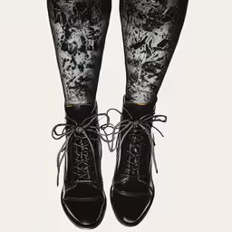 an legs in high heels are wearing black laces
