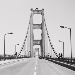people riding bikes and driving over the bridge