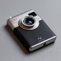 a silver digital camera sitting on a table