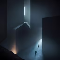 a man standing in an empty hallway with dark walls