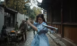 woman in costume holding up a giant gun