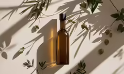 a bottle of wine on a shelf near a plant