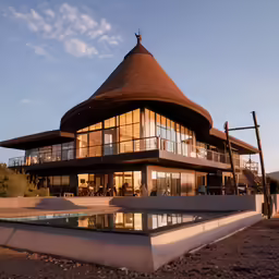 a large building sitting on top of a dirt field