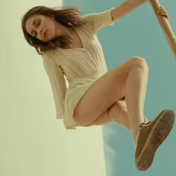 an asian girl swings a pole outside