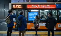 people waiting on a crowded bus at a bus stop