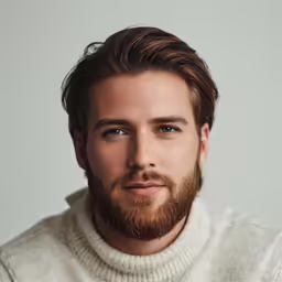 a man is wearing a turtle neck sweater