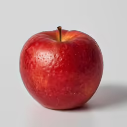 an apple sitting in the middle of a white background